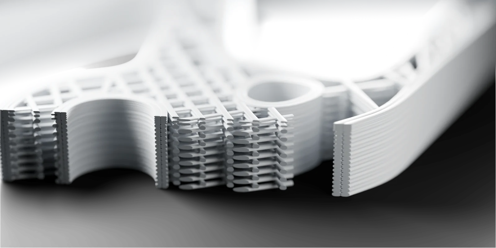 Illustration: a close view of the mount's printed layers where it is cut through: stacked beads of plastic for the walls and the infill, with four finer layers on top.